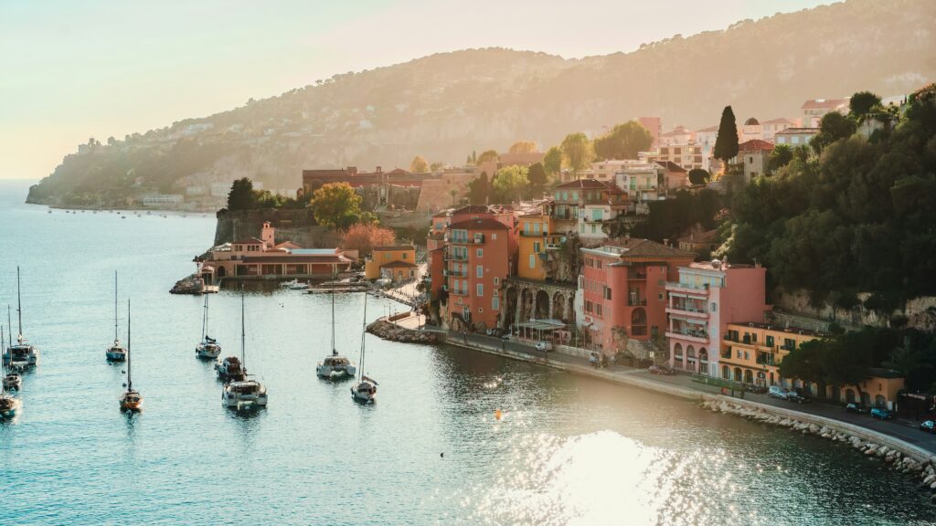 Villefranche-sur-Mer view of the colourful buildings and boats in the sea.