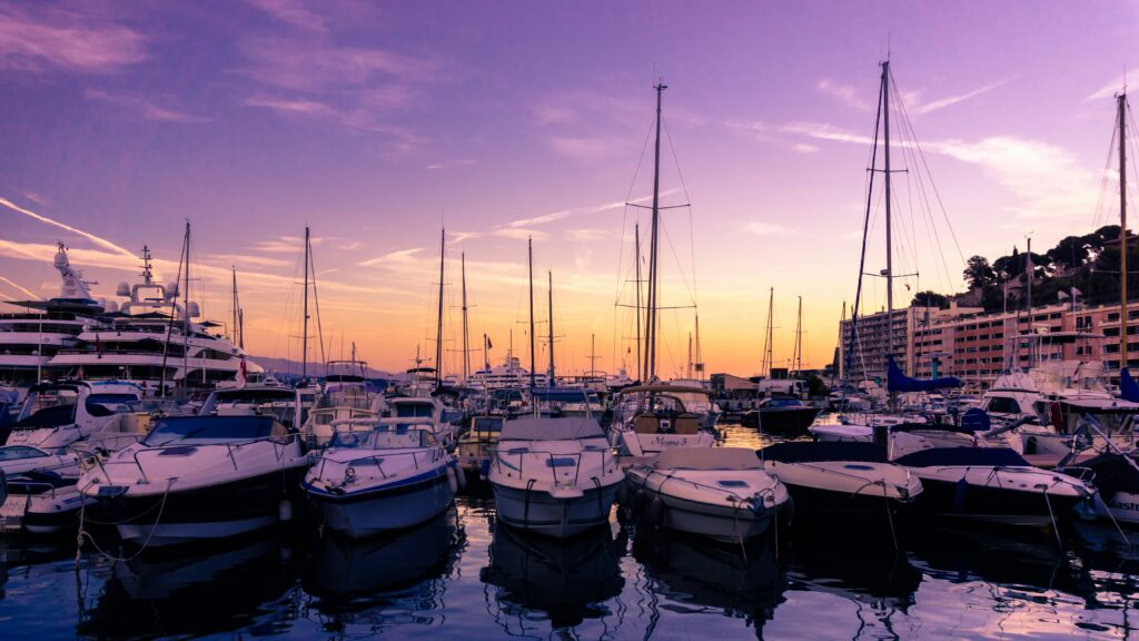 Yachts in the Monaco harbour at sunset.