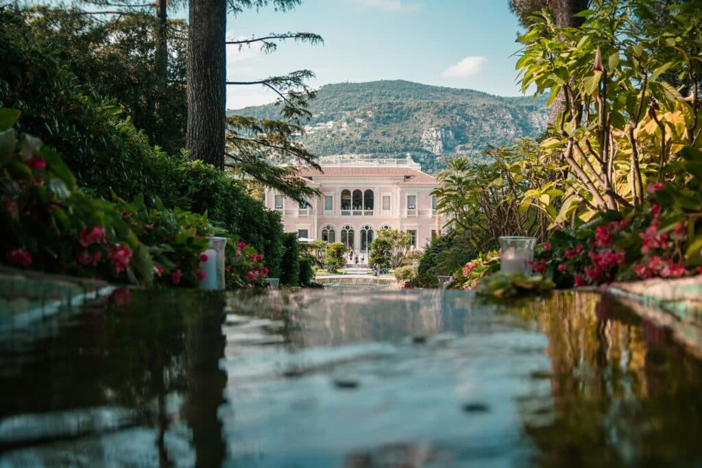 Pink facade of Villa Ephrussi de Rothschild and its manicured gardens in Saint-Jean-Cap-Ferrat