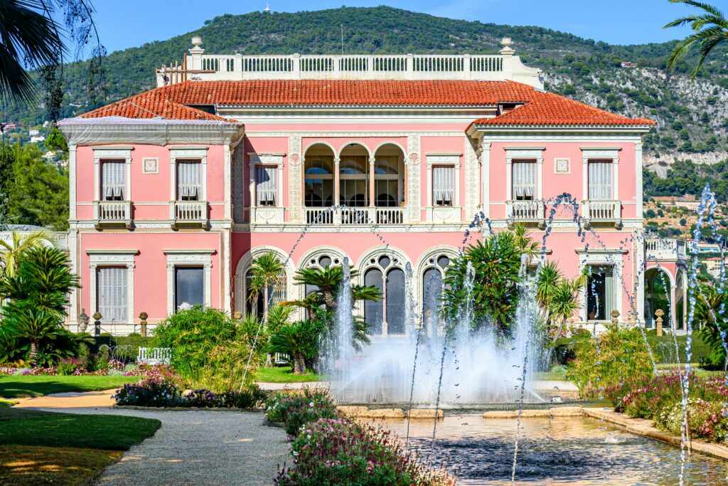 Pink facade of Villa Ephrussi de Rothschild and its manicured gardens in Saint-Jean-Cap-Ferrat